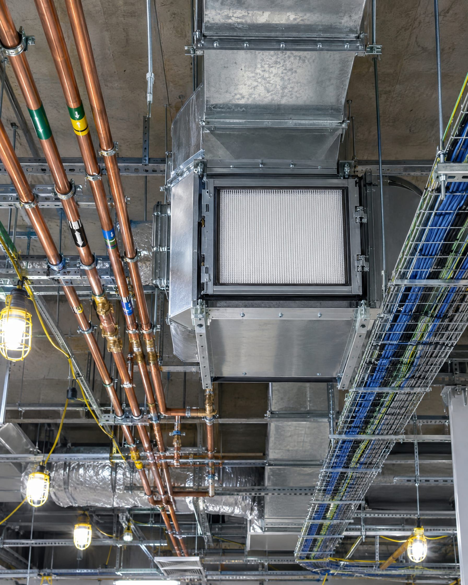 Above-ceiling services: supply duct with a HEPA housing, colour-banded copper gas pipes and cable trays